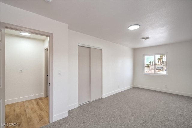 5239 Elgin Cir, Las Vegas, NV 89122 - unfurnished bedroom featuring baseboards, a closet, and light carpet
