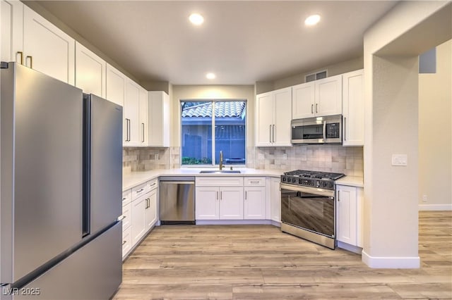 5010 Crooked Stick Way, Las Vegas, NV 89113 - kitchen featuring appliances with stainless steel finishes, a sink, light countertops, white cabinets, and recessed lighting
