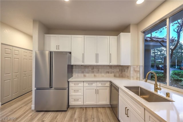 5010 Crooked Stick Way, Las Vegas, NV 89113 - kitchen featuring appliances with stainless steel finishes, a sink, white cabinets, light countertops, and backsplash