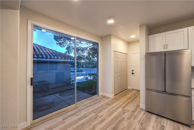 5010 Crooked Stick Way, Las Vegas, NV 89113 - kitchen featuring high end refrigerator, white cabinets, light wood-type flooring, baseboards, and recessed lighting