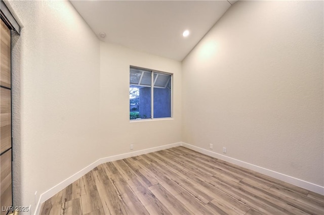 5010 Crooked Stick Way, Las Vegas, NV 89113 - empty room with light wood-type flooring, lofted ceiling, baseboards, and recessed lighting