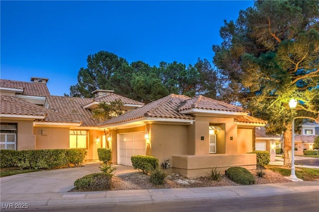 5010 Crooked Stick Way, Las Vegas, NV 89113 - mediterranean / spanish house with an attached garage, stucco siding, concrete driveway, and a tile roof