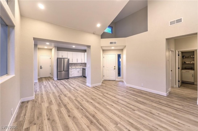 5010 Crooked Stick Way, Las Vegas, NV 89113 - unfurnished living room with high vaulted ceiling, light wood-style floors, baseboards, and recessed lighting