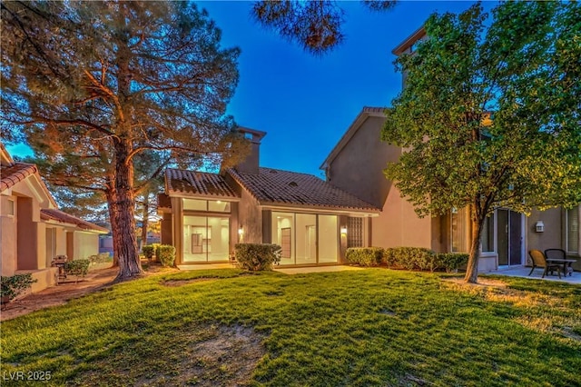 5010 Crooked Stick Way, Las Vegas, NV 89113 - back of property with a chimney, a yard, a tiled roof, a patio, and stucco siding