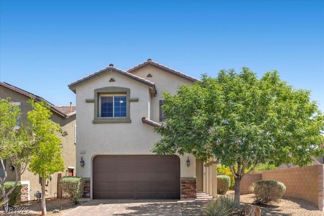 2276 Sky Island Dr, Henderson, NV 89002 - mediterranean / spanish-style home featuring an attached garage, stucco siding, a tile roof, and driveway