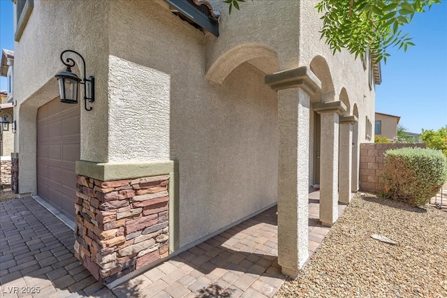 2276 Sky Island Dr, Henderson, NV 89002 - view of home's exterior with stucco siding, stone siding, and a garage