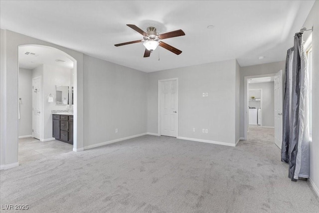 2276 Sky Island Dr, Henderson, NV 89002 - unfurnished living room featuring ceiling fan, light carpet, and arched walkways