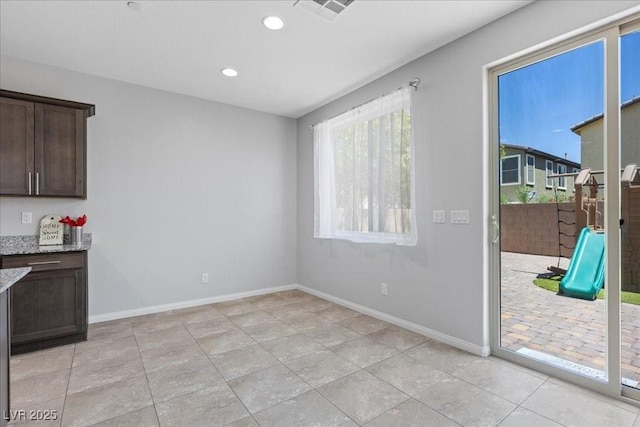 2276 Sky Island Dr, Henderson, NV 89002 - unfurnished dining area featuring light tile patterned floors and recessed lighting
