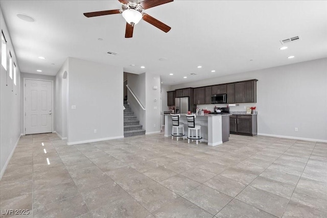 2276 Sky Island Dr, Henderson, NV 89002 - unfurnished living room with a ceiling fan, stairway, recessed lighting, and light tile patterned flooring