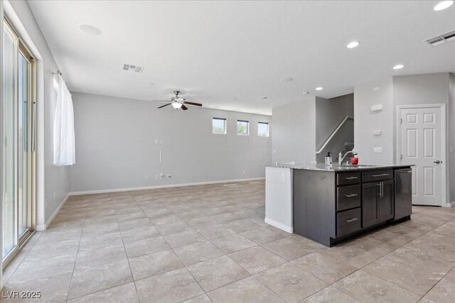 2276 Sky Island Dr, Henderson, NV 89002 - kitchen with a ceiling fan, recessed lighting, a center island with sink, light stone counters, and open floor plan