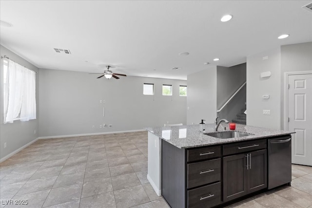 2276 Sky Island Dr, Henderson, NV 89002 - kitchen featuring dishwasher, ceiling fan, light stone counters, a kitchen island with sink, and open floor plan