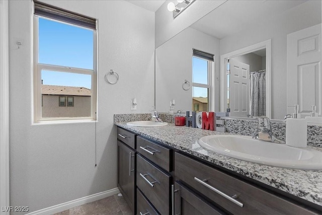 2276 Sky Island Dr, Henderson, NV 89002 - full bathroom featuring baseboards and double vanity