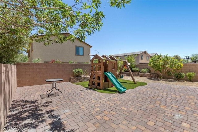 2276 Sky Island Dr, Henderson, NV 89002 - fenced backyard featuring a playground and a patio area