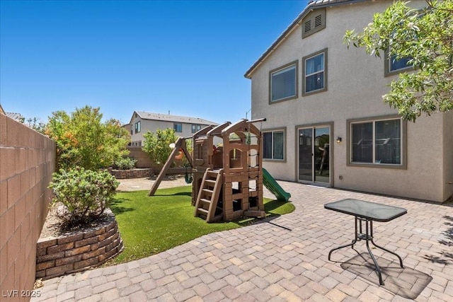 2276 Sky Island Dr, Henderson, NV 89002 - fenced backyard with a playground and a patio