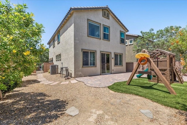 2276 Sky Island Dr, Henderson, NV 89002 - back of house with a playground, stucco siding, and a patio