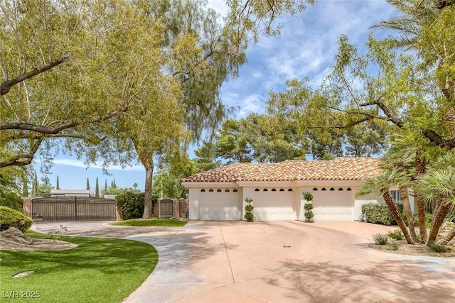 8130 Cassian Ct, Las Vegas, NV 89129 - mediterranean / spanish-style house featuring stucco siding, a tile roof, driveway, fence, and a garage