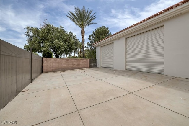 8130 Cassian Ct, Las Vegas, NV 89129 - view of patio featuring fence and a detached garage