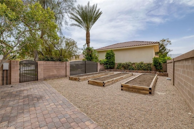 8130 Cassian Ct, Las Vegas, NV 89129 - view of patio featuring a gate, a vegetable garden, and a fenced backyard