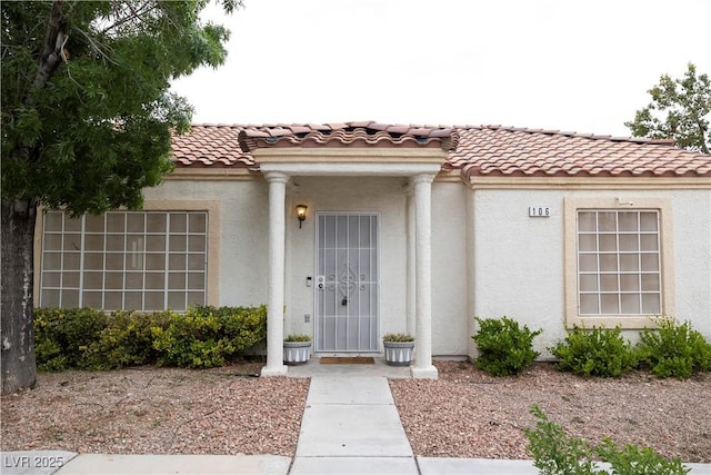 5400 Tassara Way Unit 106, Las Vegas, NV 89108 - doorway to property with stucco siding and a tiled roof