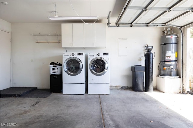 5400 Tassara Way Unit 106, Las Vegas, NV 89108 - laundry area featuring strapped water heater, washing machine and dryer, a garage, and cabinet space