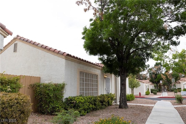 5400 Tassara Way Unit 106, Las Vegas, NV 89108 - view of side of property featuring stucco siding and a tiled roof