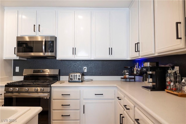 5400 Tassara Way Unit 106, Las Vegas, NV 89108 - kitchen with appliances with stainless steel finishes, white cabinets, and light countertops