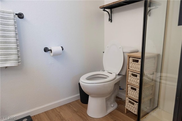 5400 Tassara Way Unit 106, Las Vegas, NV 89108 - bathroom with baseboards, wood finished floors, toilet, and a shower with door
