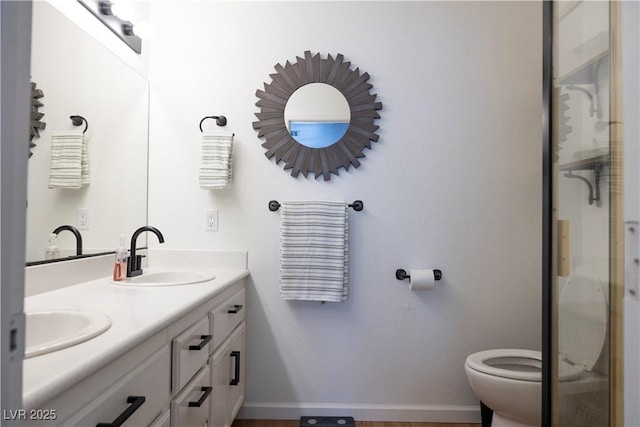 5400 Tassara Way Unit 106, Las Vegas, NV 89108 - bathroom with double vanity, baseboards, toilet, and a stall shower