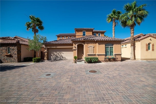 153 Via Di Mello, Henderson, NV 89011 - mediterranean / spanish-style home with stucco siding, decorative driveway, an attached garage, and a tiled roof