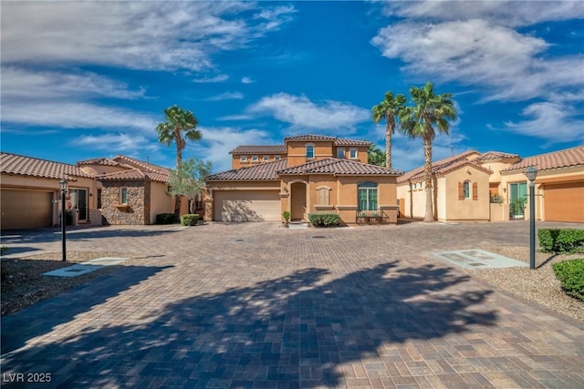 153 Via Di Mello, Henderson, NV 89011 - mediterranean / spanish house with stucco siding, a tiled roof, a garage, and decorative driveway