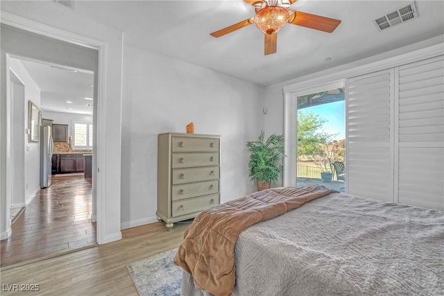 153 Via Di Mello, Henderson, NV 89011 - bedroom with access to exterior, light wood-style floors, baseboards, freestanding refrigerator, and ceiling fan