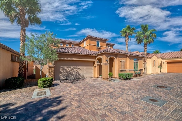 153 Via Di Mello, Henderson, NV 89011 - mediterranean / spanish house with stucco siding, an attached garage, a tile roof, and driveway