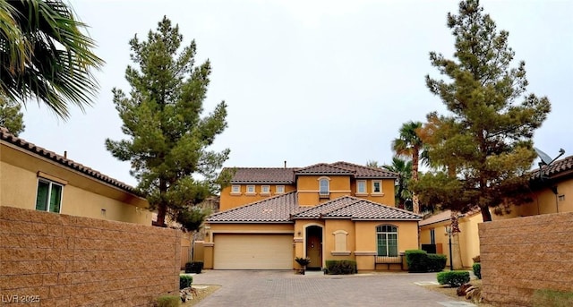 153 Via Di Mello, Henderson, NV 89011 - mediterranean / spanish house featuring a tiled roof, decorative driveway, a garage, and stucco siding
