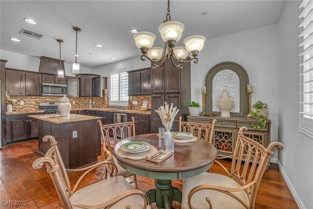 153 Via Di Mello, Henderson, NV 89011 - dining area with dark wood-style flooring, a chandelier, and recessed lighting