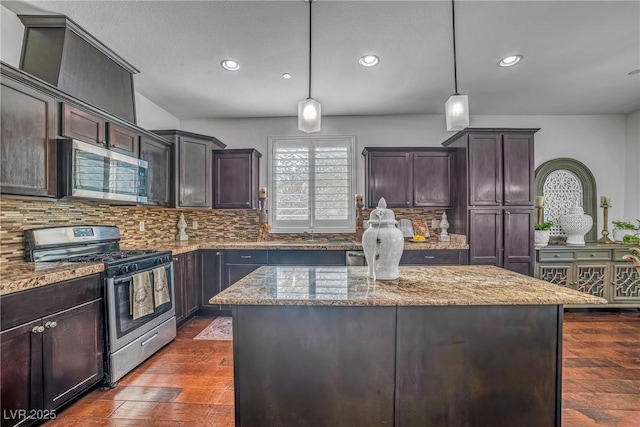 153 Via Di Mello, Henderson, NV 89011 - kitchen with stainless steel appliances, recessed lighting, light stone countertops, dark wood-style flooring, and decorative backsplash