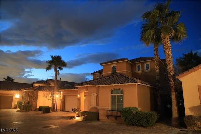 153 Via Di Mello, Henderson, NV 89011 - mediterranean / spanish-style house with an attached garage, driveway, a tile roof, and stucco siding