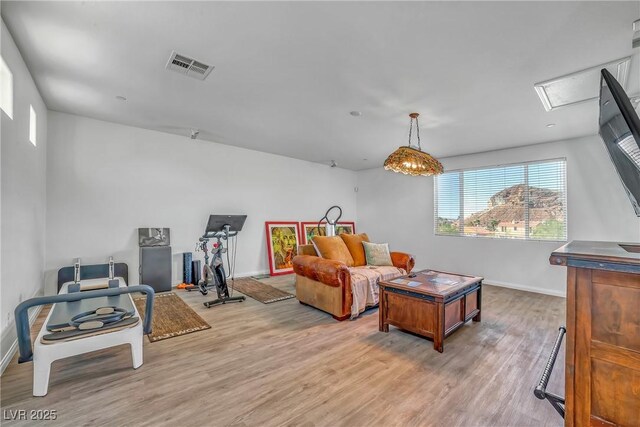 153 Via Di Mello, Henderson, NV 89011 - living room featuring light wood finished floors, baseboards, and attic access
