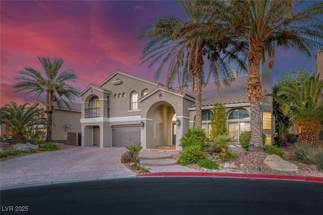 11158 Antonine Wall Ct, Las Vegas, NV 89141 - mediterranean / spanish home featuring stucco siding, an attached garage, driveway, a balcony, and a tiled roof