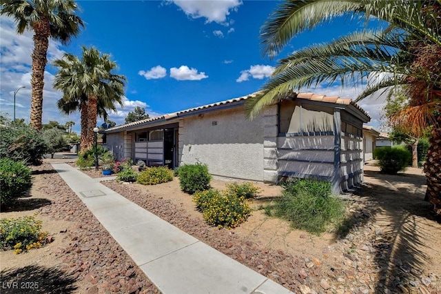 227 N Lamb Blvd Unit B, Las Vegas, NV 89110 - view of property exterior featuring stucco siding and a tile roof