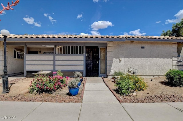 227 N Lamb Blvd Unit B, Las Vegas, NV 89110 - view of front facade featuring a tile roof and stucco siding