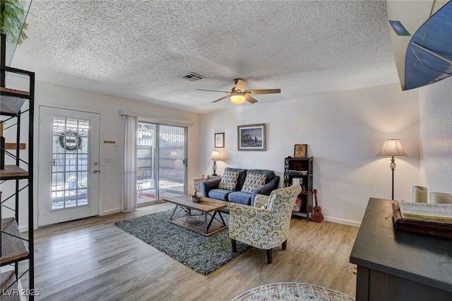 227 N Lamb Blvd Unit B, Las Vegas, NV 89110 - living area featuring a ceiling fan, wood finished floors, a textured ceiling, and baseboards