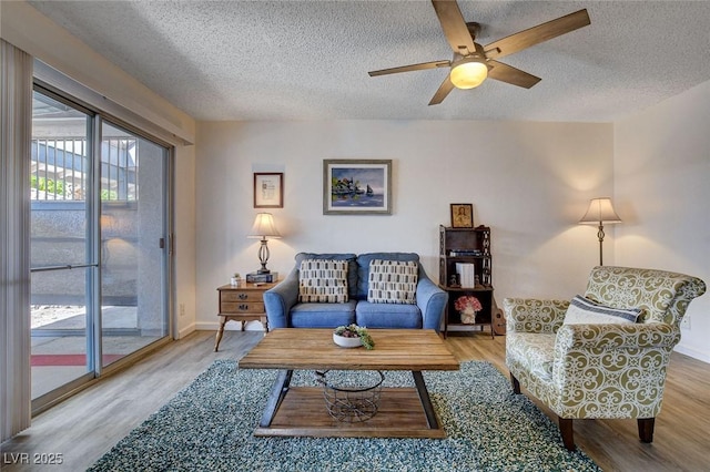 227 N Lamb Blvd Unit B, Las Vegas, NV 89110 - living area featuring a textured ceiling, wood finished floors, a ceiling fan, and baseboards
