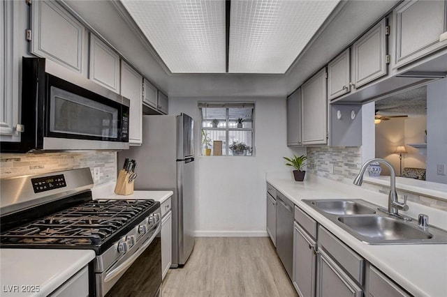 227 N Lamb Blvd Unit B, Las Vegas, NV 89110 - kitchen featuring appliances with stainless steel finishes, a sink, gray cabinetry, baseboards, and a ceiling fan
