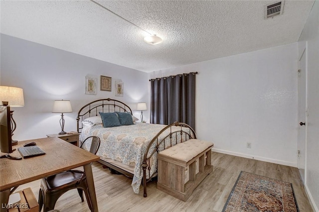 227 N Lamb Blvd Unit B, Las Vegas, NV 89110 - bedroom with a textured ceiling, light wood-style flooring, and baseboards
