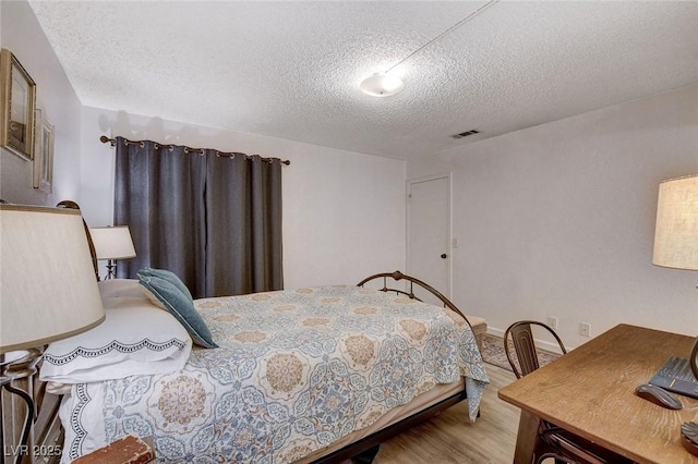 227 N Lamb Blvd Unit B, Las Vegas, NV 89110 - bedroom with a textured ceiling and wood finished floors