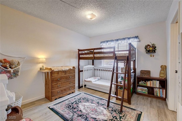 227 N Lamb Blvd Unit B, Las Vegas, NV 89110 - bedroom with a textured ceiling, wood finished floors, and baseboards