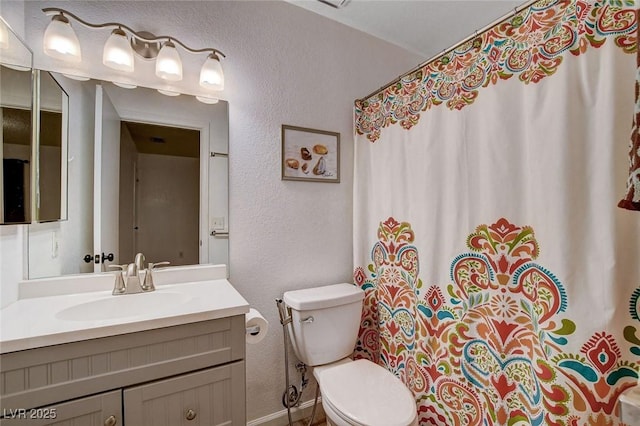 227 N Lamb Blvd Unit B, Las Vegas, NV 89110 - full bathroom with a textured wall, toilet, vanity, baseboards, and curtained shower