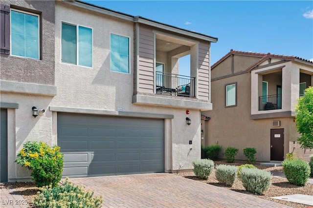 3729 Canis Minor Ln Unit 10206, Henderson, NV 89052 - townhome / multi-family property featuring an attached garage, decorative driveway, a balcony, and stucco siding