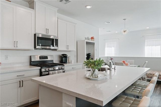 3729 Canis Minor Ln Unit 10206, Henderson, NV 89052 - kitchen featuring stainless steel appliances, plenty of natural light, a kitchen island with sink, white cabinetry, and recessed lighting