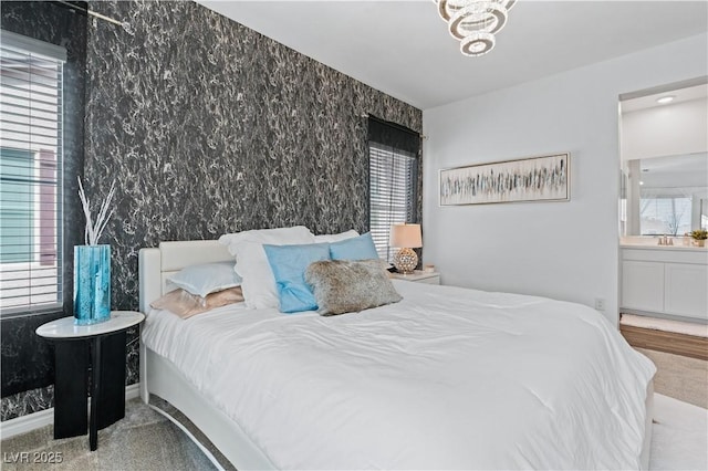 3729 Canis Minor Ln Unit 10206, Henderson, NV 89052 - bedroom with wallpapered walls, carpet flooring, multiple windows, and ensuite bath